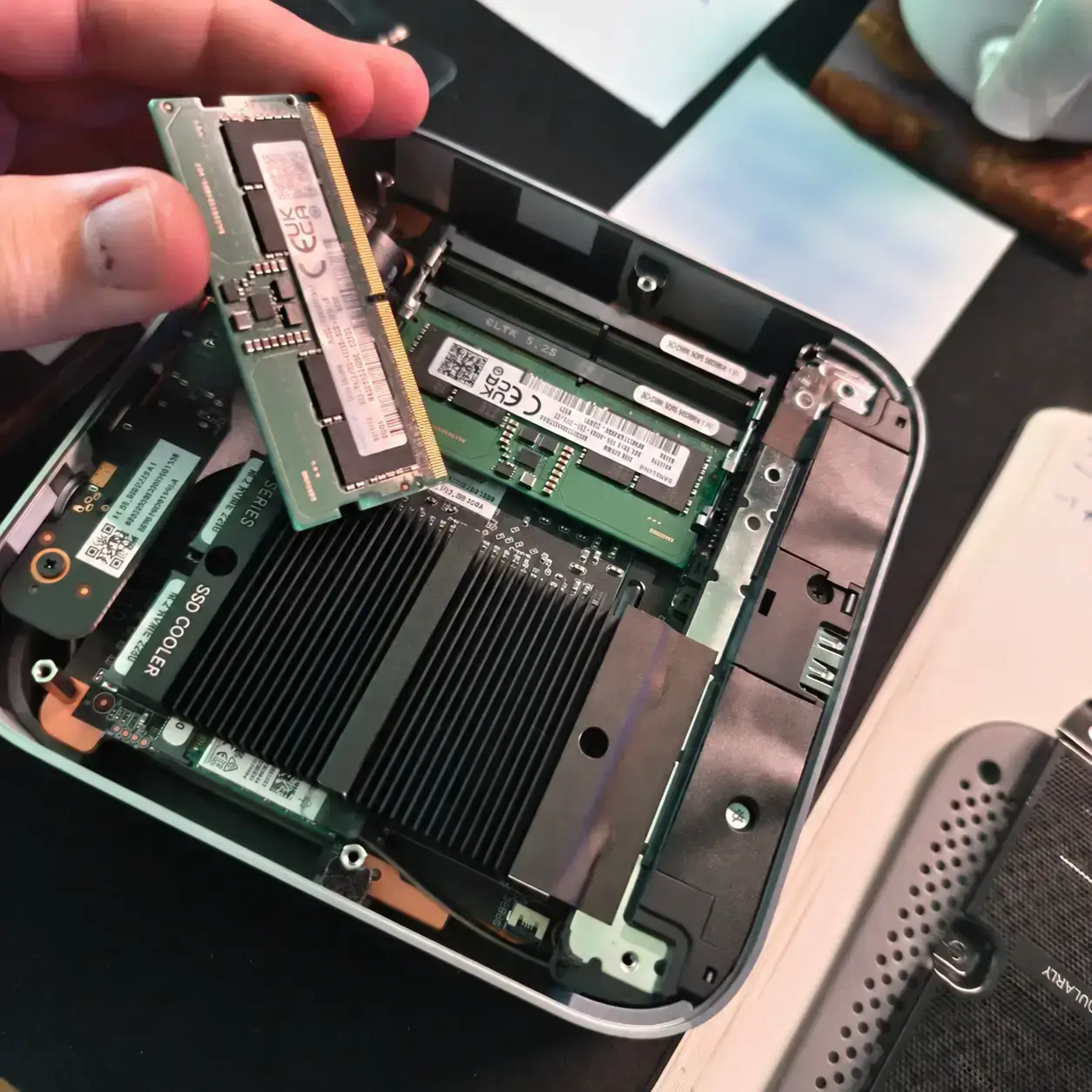 Adding RAM to my open Beelink mini PC, with one stick already in place.